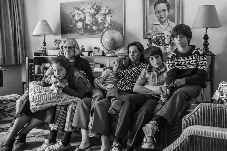 A family sitting on a couch in Roma.